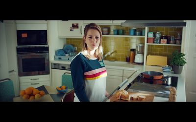 a woman standing in a kitchen next to a counter