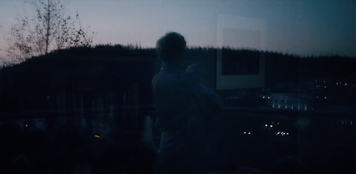 a blurry image of a person standing in the dark