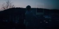 a blurry image of a person standing in the dark