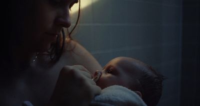 a woman holding a baby in her arms