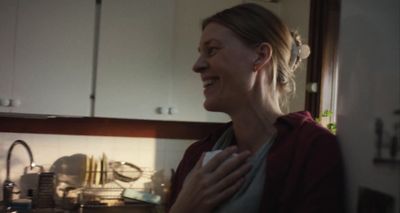 a woman standing in a kitchen next to a sink