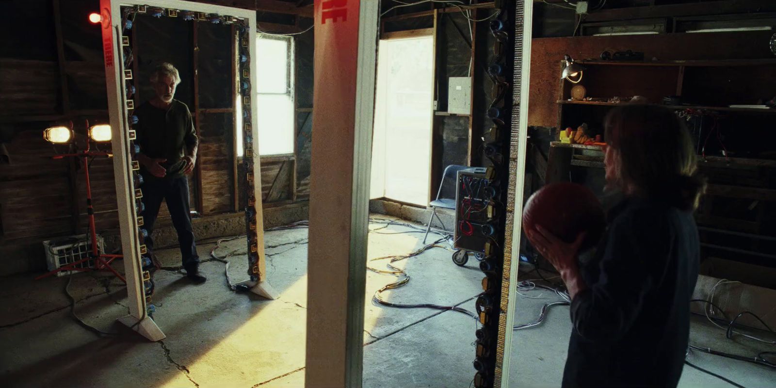 a couple of people standing in a room with mirrors