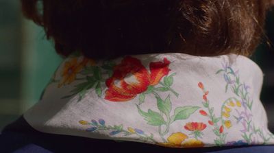 the back of a woman's head with a flowered necktie