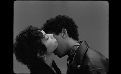 a black and white photo of two people kissing