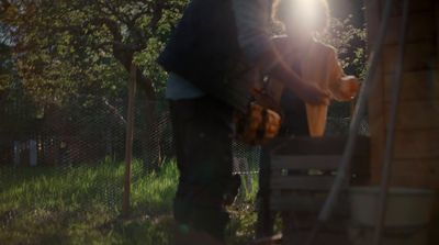 a man standing next to a dog on top of a lush green field