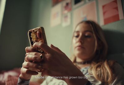 a woman holding a cell phone in her hand