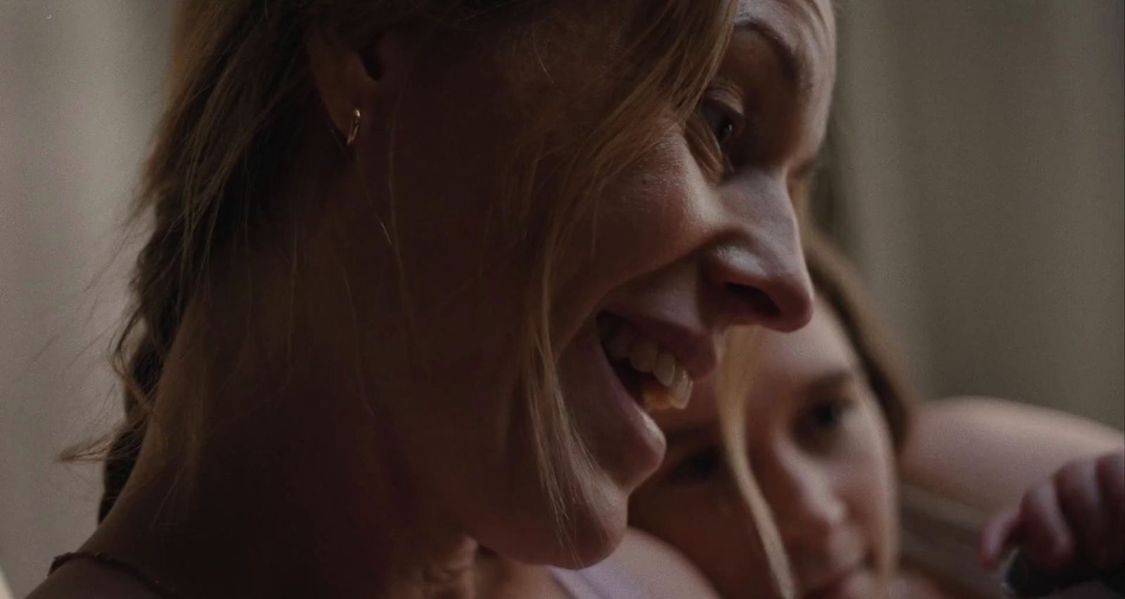 a close up of two women smiling and looking at something