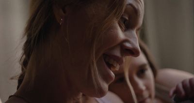 a close up of two women smiling and looking at something