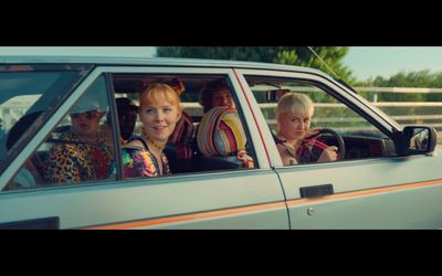 a group of women sitting in the passenger seat of a car