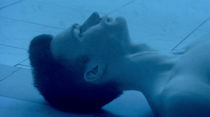 a man laying on the floor with his head in the air
