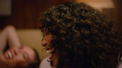 a close up of a person with curly hair