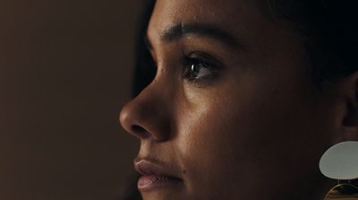 a close up of a person wearing a pair of earrings