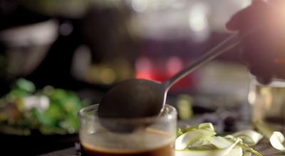 a spoon with some food on a table