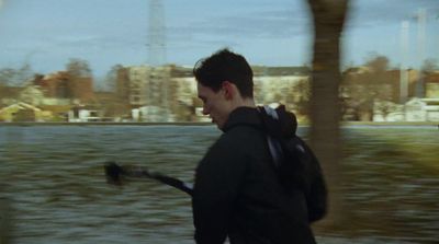 a man walking down a street with a backpack on