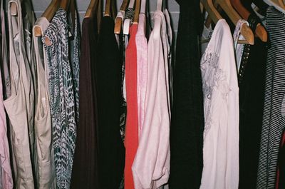 a bunch of clothes hanging on a rack