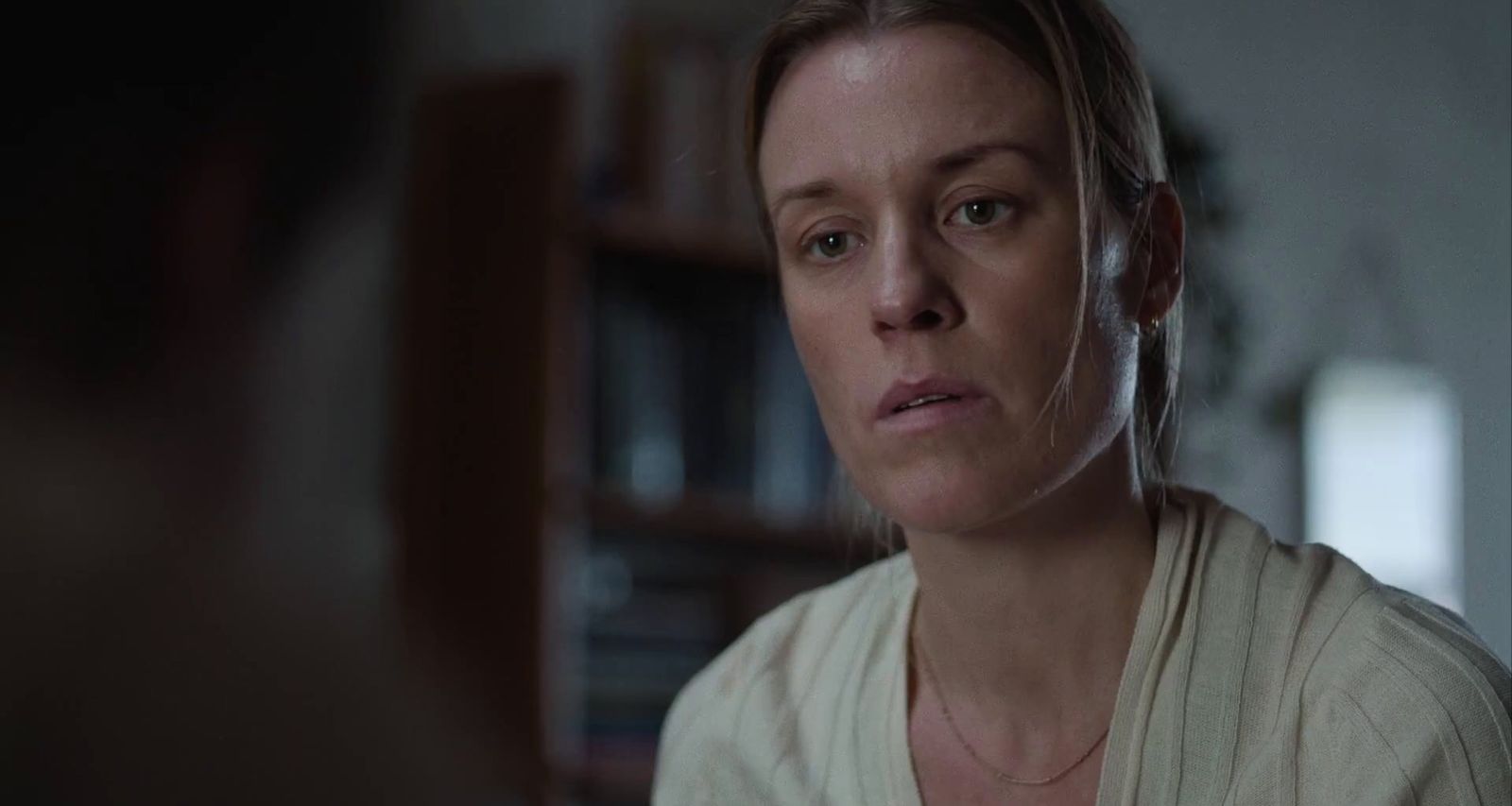 a woman in a white shirt looking at a man