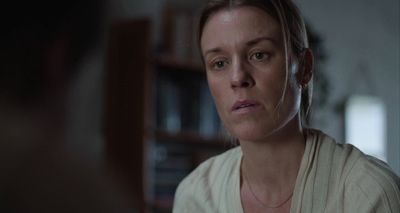 a woman in a white shirt looking at a man