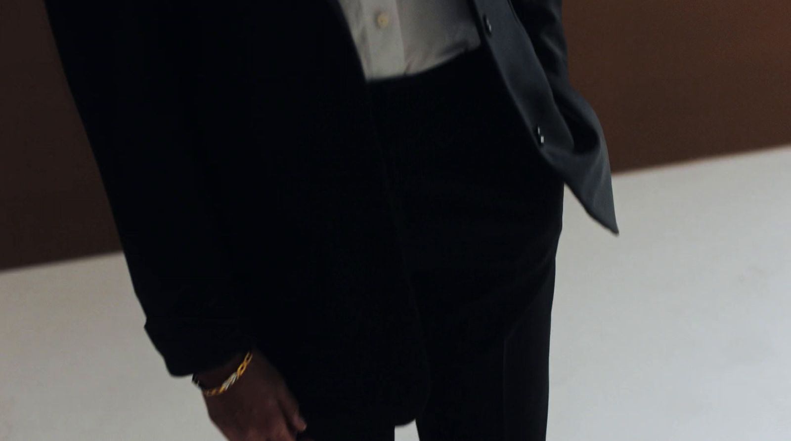 a man in a suit and tie holding a cell phone