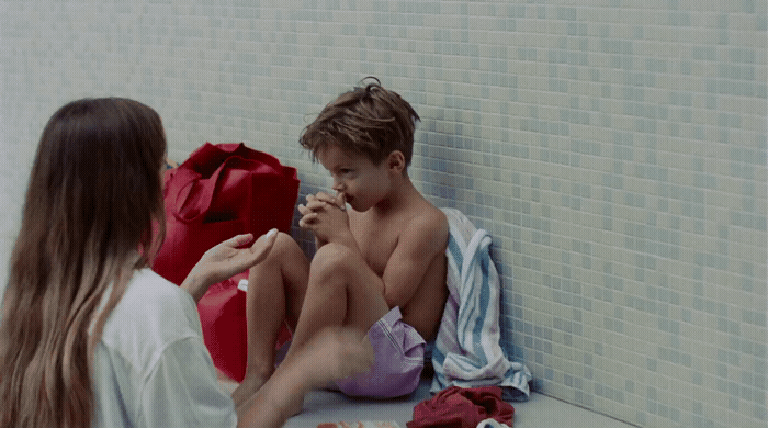 a boy and a girl sitting on the floor next to each other