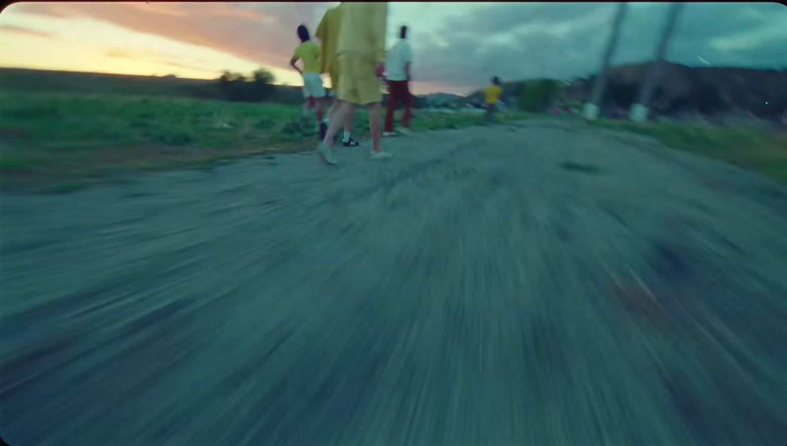 a blurry photo of people walking down a dirt road