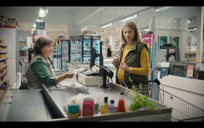 a woman standing at a cash register in a store