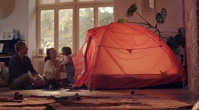 a group of people sitting on the floor next to a tent