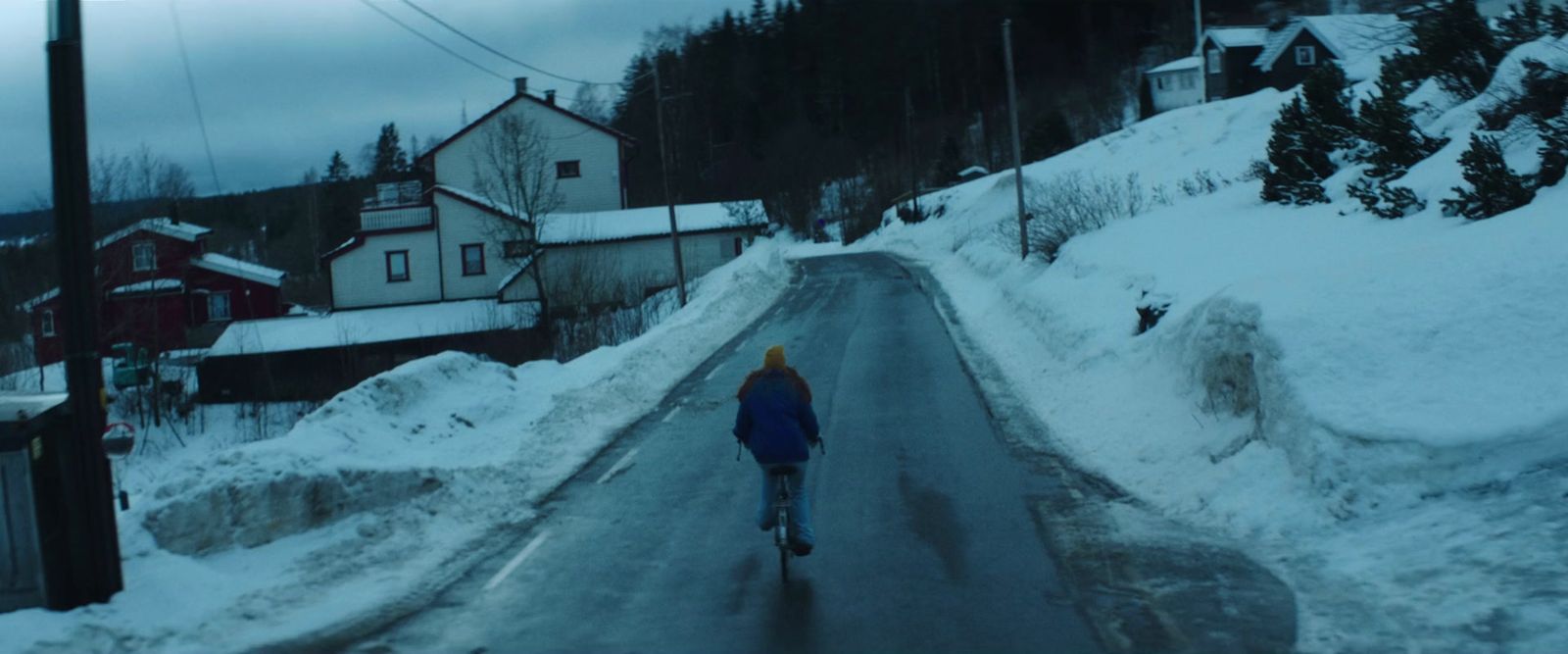 a person walking down a snow covered road