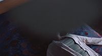 a person laying on a bed with their feet on a pillow