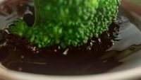 a close up of a piece of broccoli in a bowl