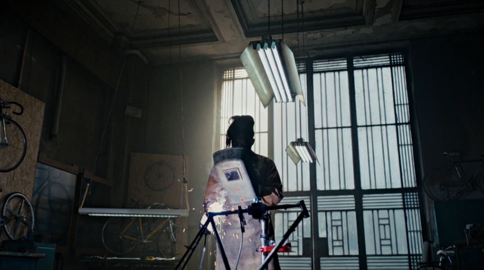 a man standing next to a bike in a room