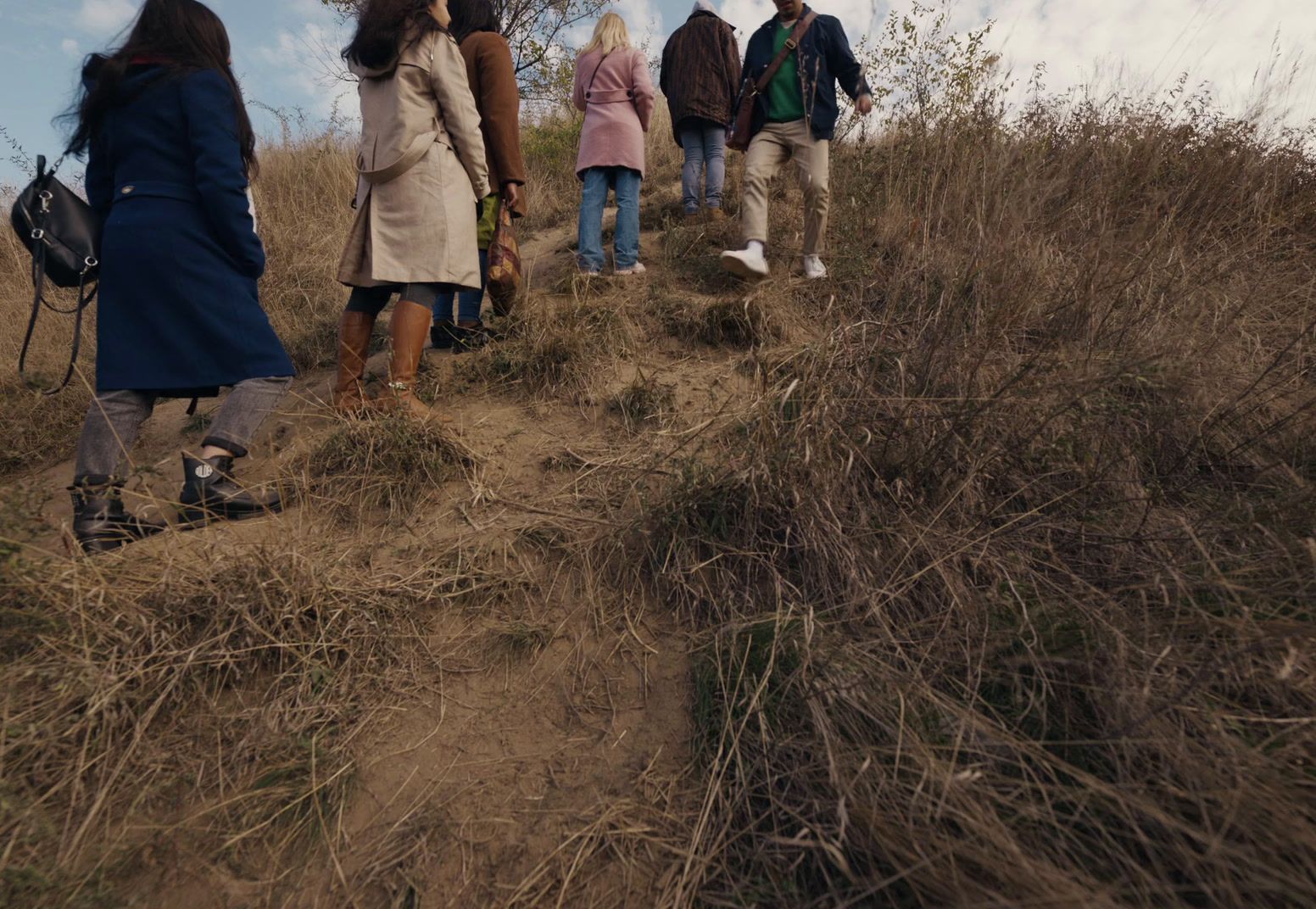 a group of people walking up a hill