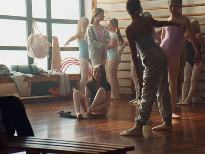 a group of people standing on top of a hard wood floor