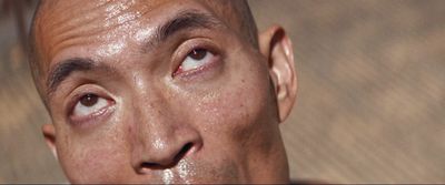 a close up of a man's face with water on his face