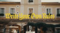 a blurry photo of a building with the words write your own rules