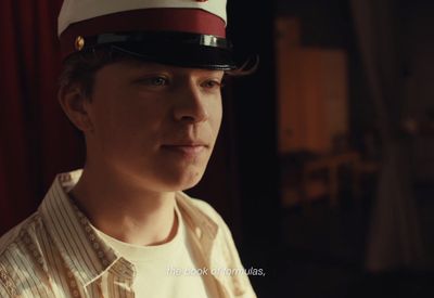 a young man wearing a red and white hat
