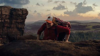 a couple of people that are standing on a hill