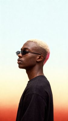 a man with a shaved head wearing sunglasses