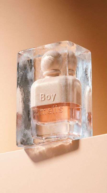 a bottle of perfume sitting on top of an ice block
