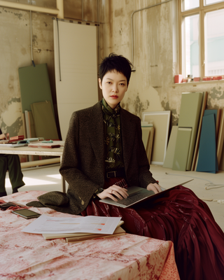 a woman sitting on a table holding a book