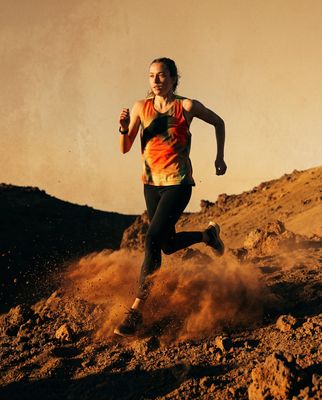 a woman running in the desert on a sunny day