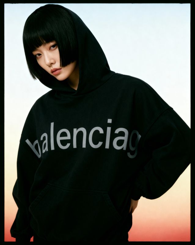 a woman wearing a black hoodie with the word valencia on it