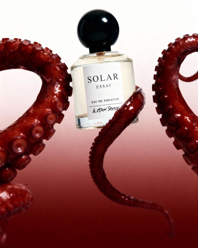 a bottle of perfume sitting on top of an octopus