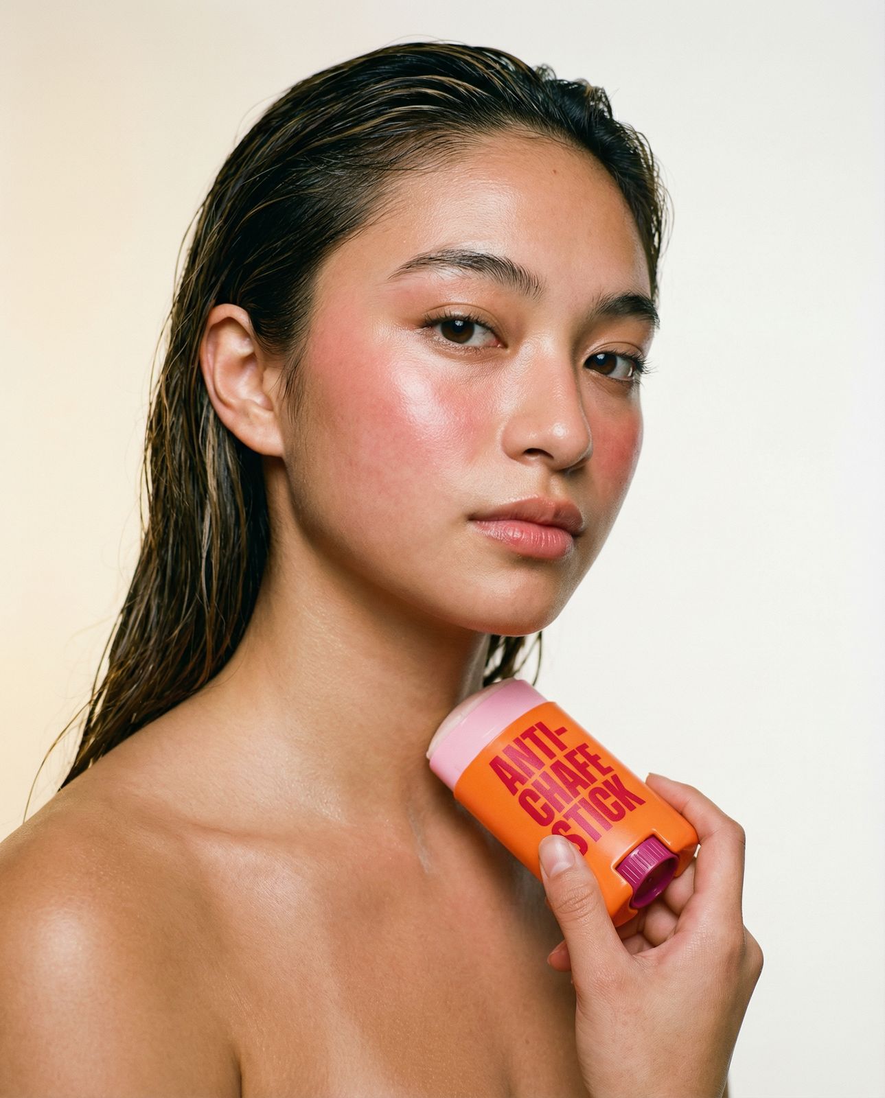 a woman holding a tube of sunscreen in her hand