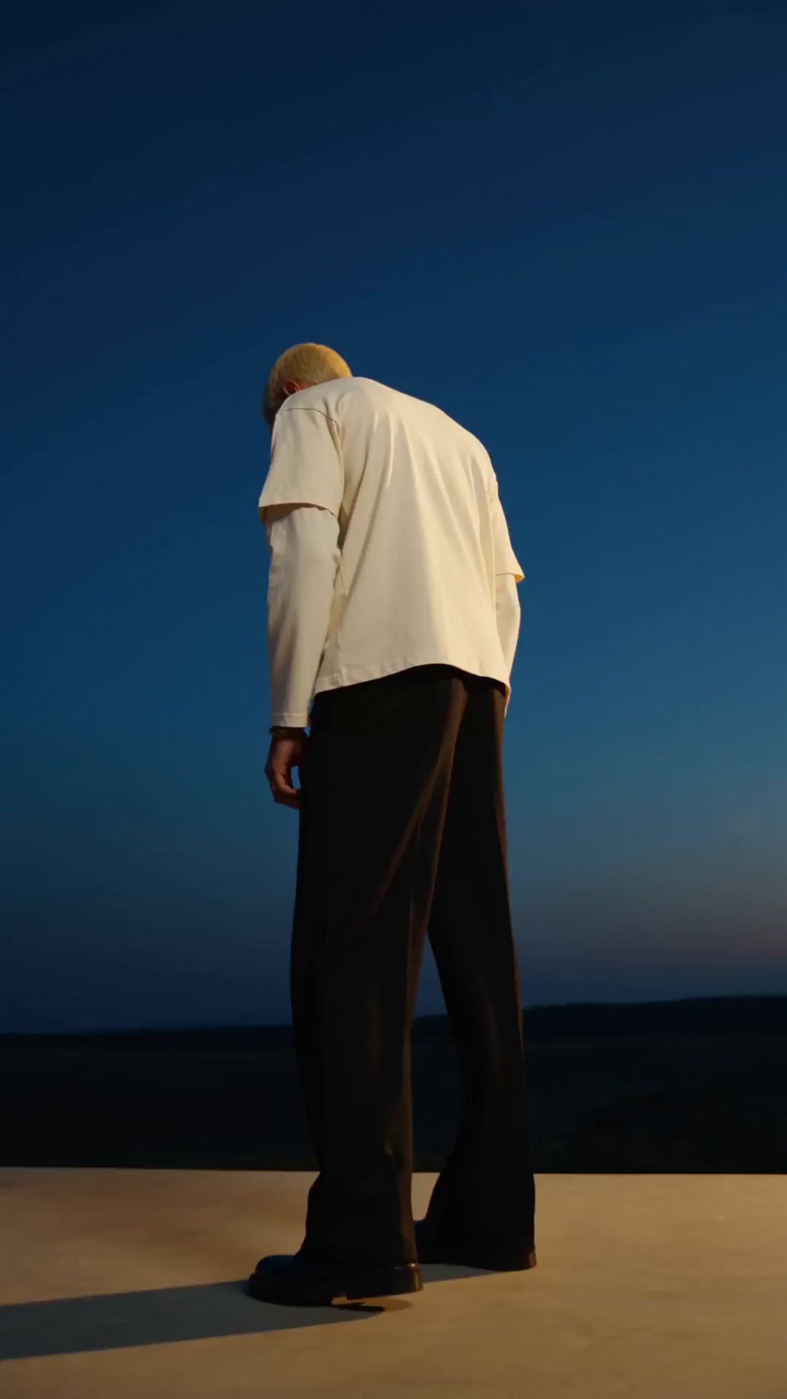 a man in a white shirt and black pants