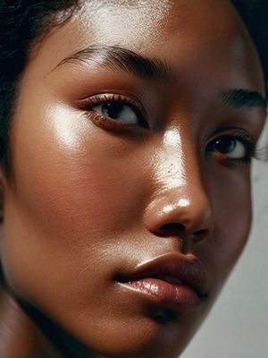 a close up of a woman's face wearing a necklace