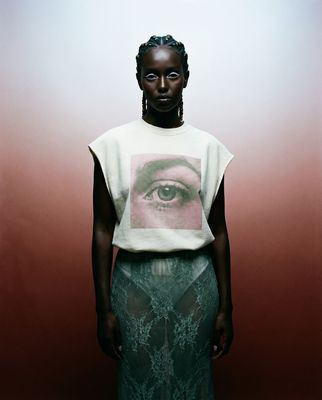 a woman standing in front of a red wall