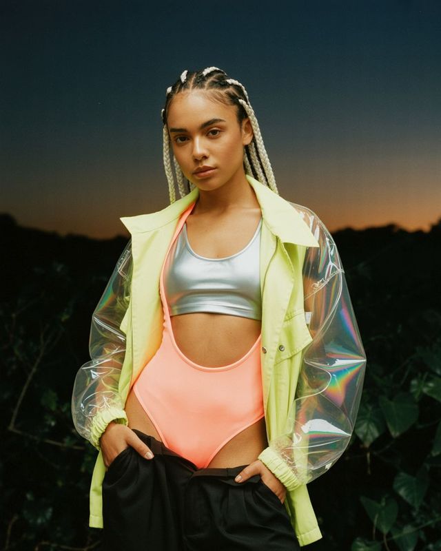 a woman with braids wearing a neon crop top