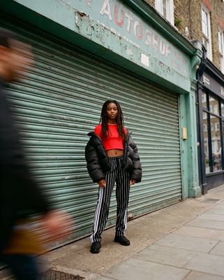 a woman standing in front of a garage door