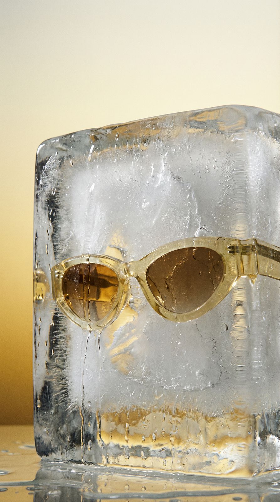 a pair of sunglasses sitting on top of an ice block