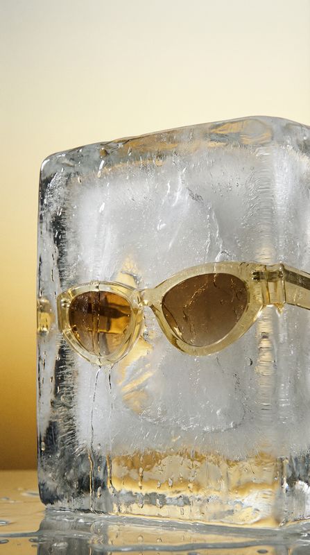 a pair of sunglasses sitting on top of an ice block